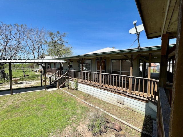 back of property featuring a yard and a porch