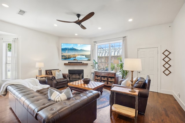 living room featuring hardwood / wood-style floors, ceiling fan, and plenty of natural light