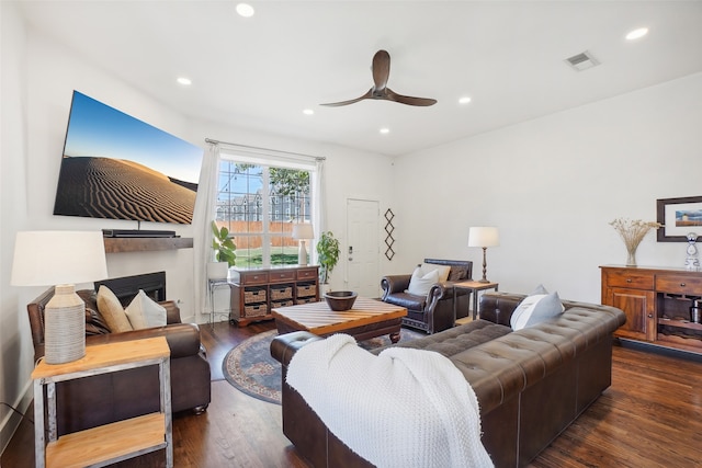 living room with ceiling fan and dark hardwood / wood-style floors