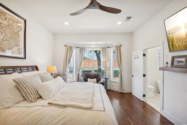 bedroom with ensuite bath, ceiling fan, dark hardwood / wood-style flooring, and access to exterior