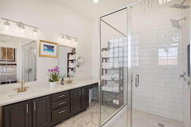 bathroom with vanity and a shower with shower door