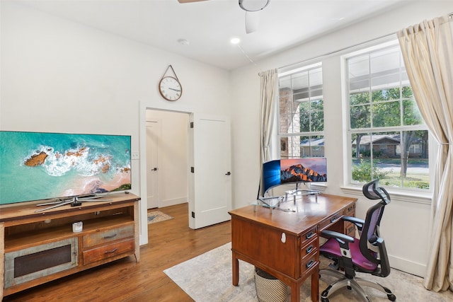 home office featuring ceiling fan, plenty of natural light, and light wood-type flooring