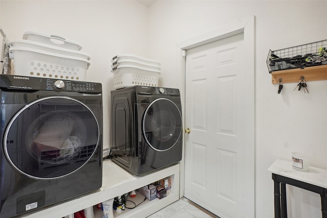 washroom with washing machine and clothes dryer