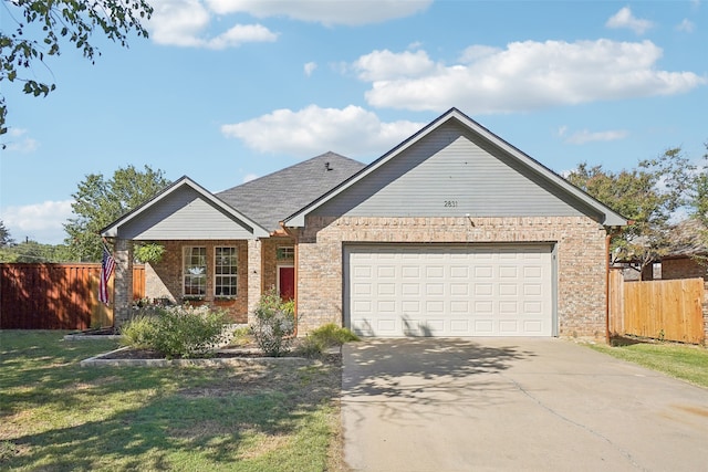 view of front of property with a front lawn and a garage