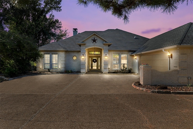 french country home featuring a garage