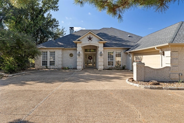 french country style house featuring a garage