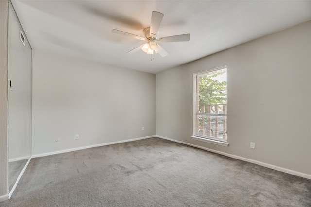 carpeted empty room featuring ceiling fan