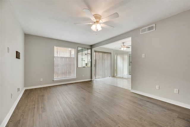 empty room with ceiling fan and wood-type flooring