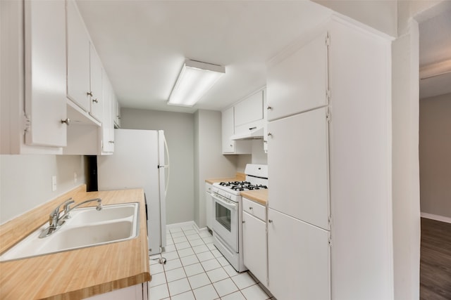 kitchen with sink, white cabinetry, custom range hood, and white appliances