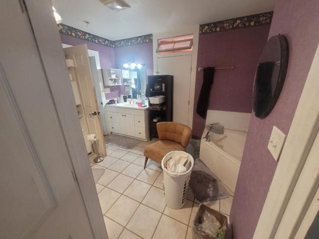 bathroom featuring vanity, a tub to relax in, and tile patterned floors