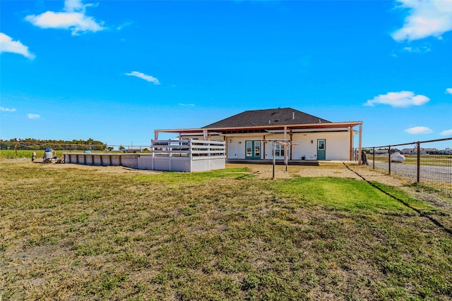 back of property with a patio area and a lawn