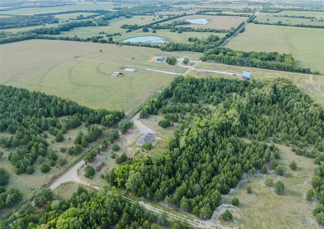 birds eye view of property with a water view and a rural view