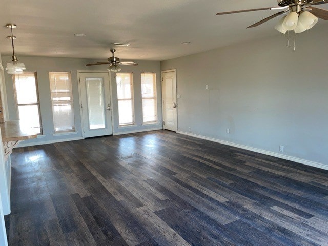 interior space with ceiling fan and dark hardwood / wood-style flooring