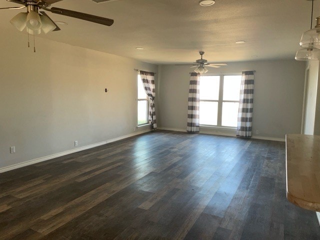 spare room featuring ceiling fan and dark hardwood / wood-style flooring