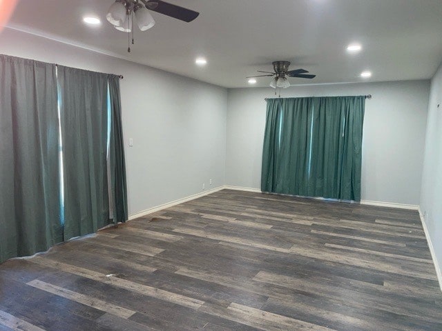 empty room featuring ceiling fan and dark hardwood / wood-style flooring