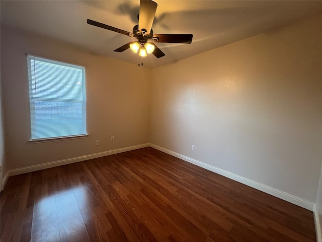 empty room featuring dark wood-type flooring and ceiling fan