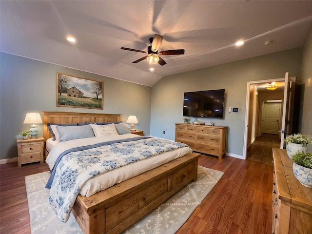 bedroom with ceiling fan, dark hardwood / wood-style flooring, and vaulted ceiling