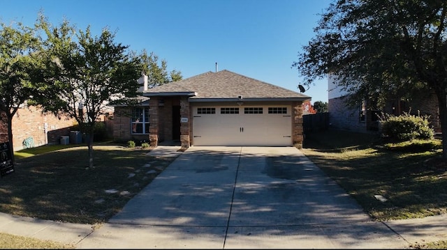 view of front of house featuring a garage and a front yard