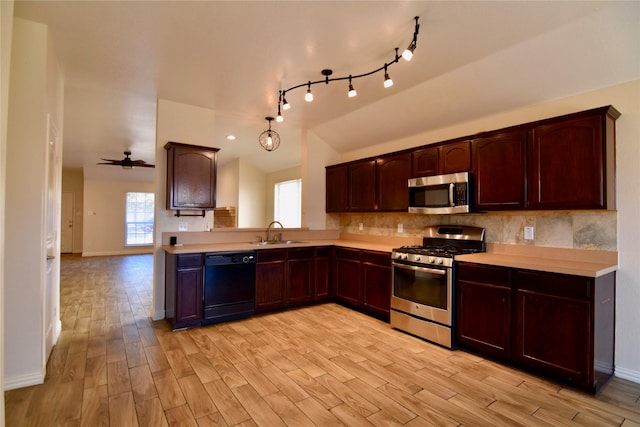 kitchen featuring lofted ceiling, sink, light hardwood / wood-style flooring, ceiling fan, and appliances with stainless steel finishes