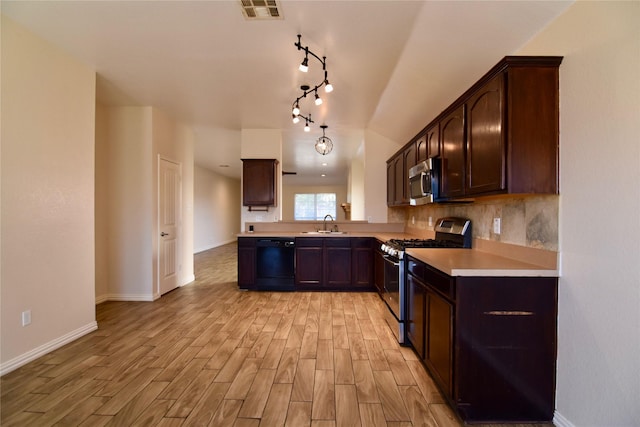 kitchen featuring sink, light wood-type flooring, tasteful backsplash, dark brown cabinets, and stainless steel appliances