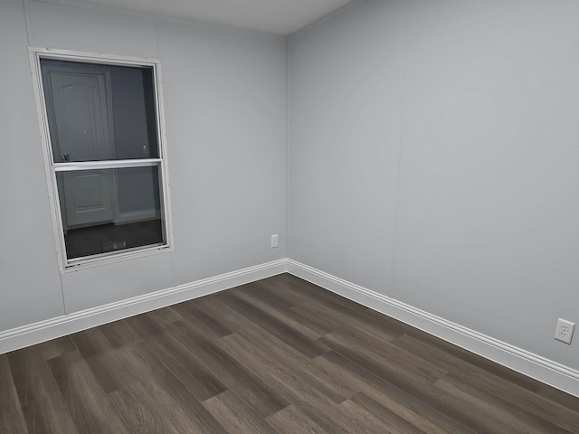 spare room with dark hardwood / wood-style flooring