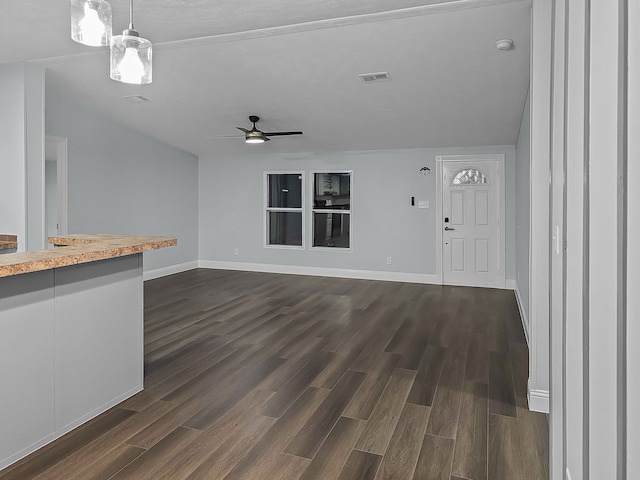 unfurnished living room featuring dark wood-type flooring, ceiling fan, and lofted ceiling