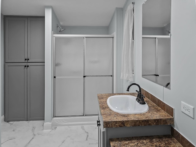 bathroom featuring vanity and a shower with shower door