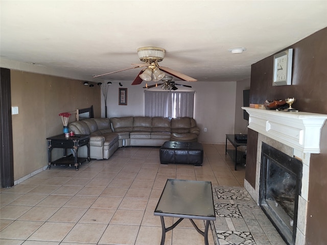 living room with light tile patterned flooring, a fireplace, and ceiling fan