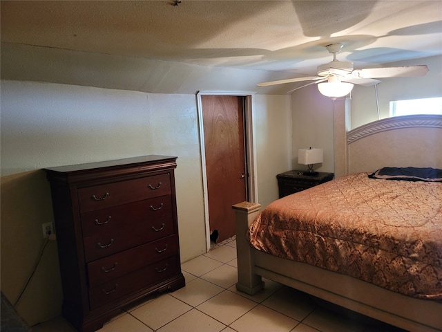 bedroom with ceiling fan and light tile patterned flooring