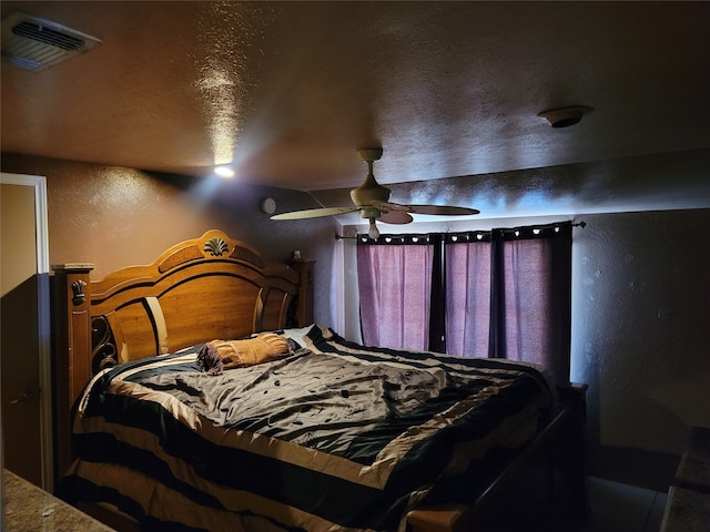 bedroom with a textured ceiling and ceiling fan