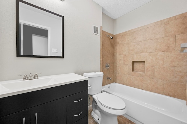 full bathroom with toilet, a textured ceiling, tiled shower / bath combo, and vanity