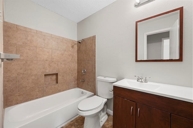 full bathroom with vanity, tiled shower / bath combo, a textured ceiling, and toilet