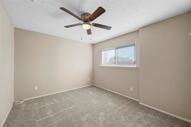 spare room with a textured ceiling, carpet floors, and ceiling fan