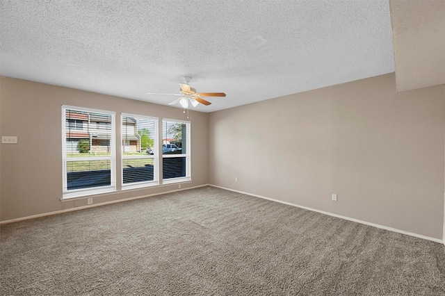 spare room featuring ceiling fan, a textured ceiling, and carpet floors