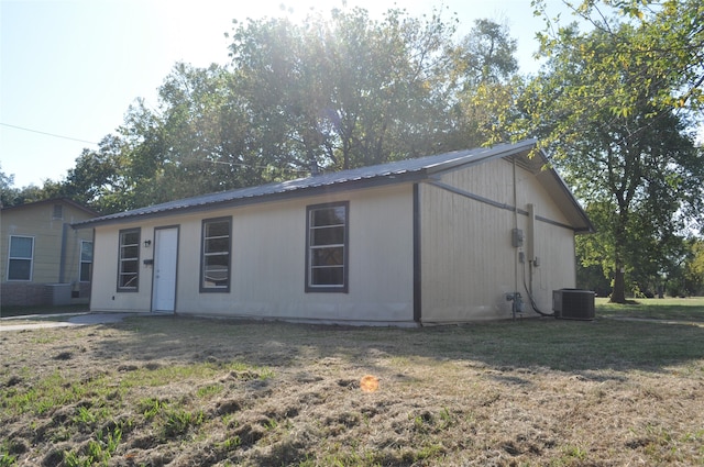 exterior space featuring a front yard and central AC unit