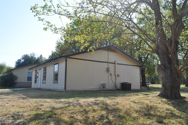 view of property exterior with a yard and cooling unit