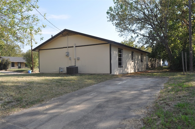 view of side of property with a lawn