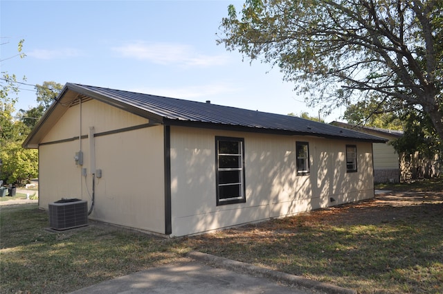 view of property exterior featuring a lawn and cooling unit