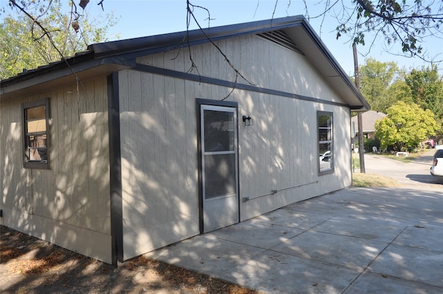 view of side of property with a patio area