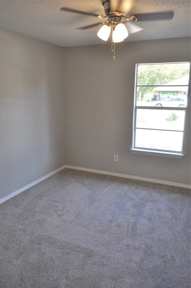 unfurnished room featuring a textured ceiling, carpet floors, and ceiling fan