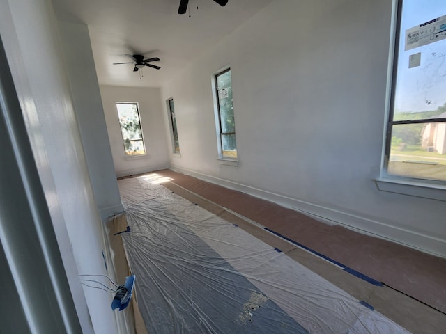 interior space with ceiling fan