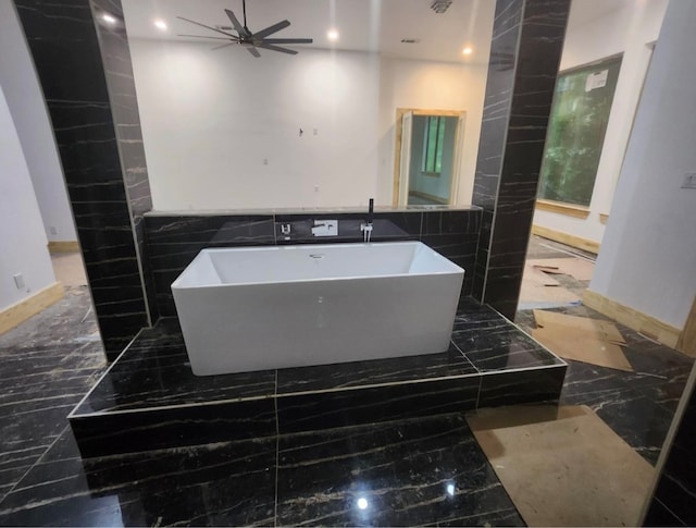 bathroom with a tub and ceiling fan