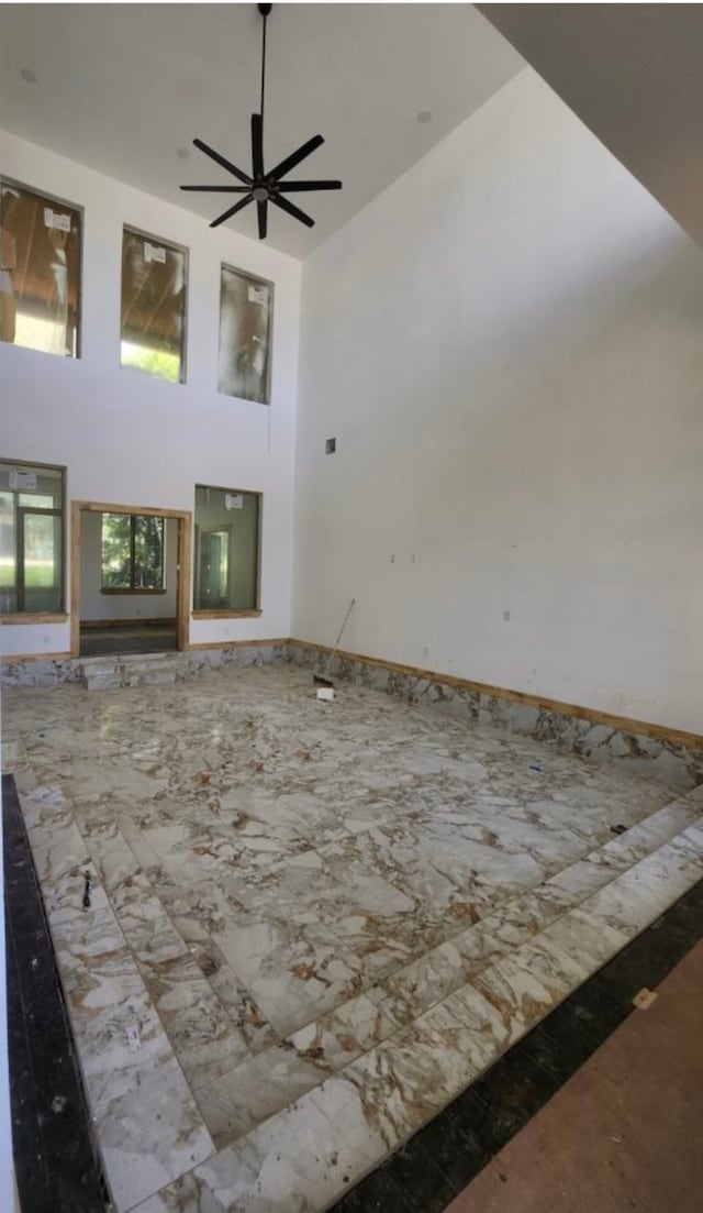 living room featuring ceiling fan and high vaulted ceiling