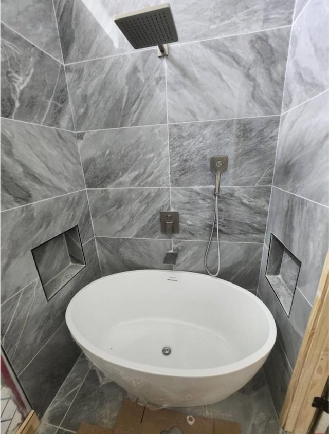 bathroom featuring tile walls and walk in shower