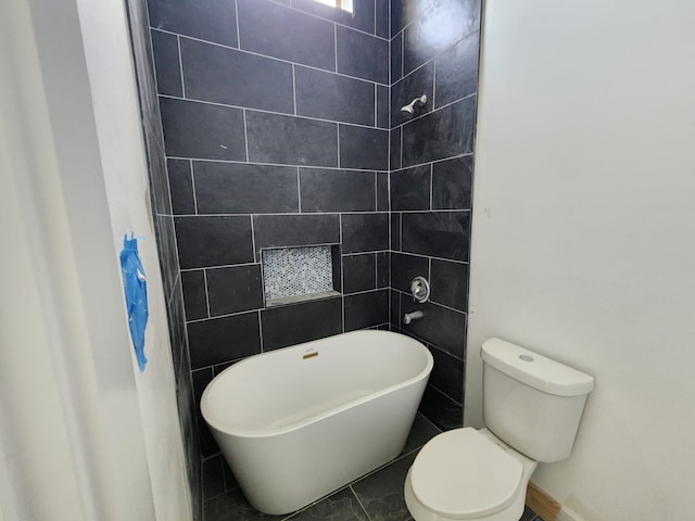 bathroom with toilet and a tub