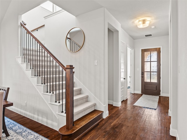 foyer entrance with dark hardwood / wood-style flooring