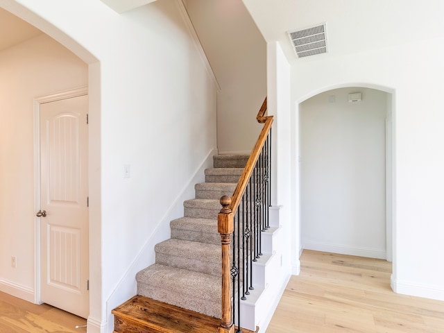 stairs with hardwood / wood-style flooring