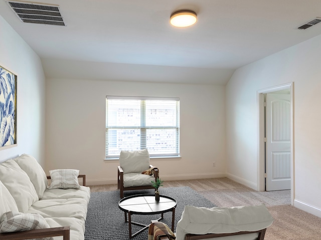 carpeted living room featuring vaulted ceiling