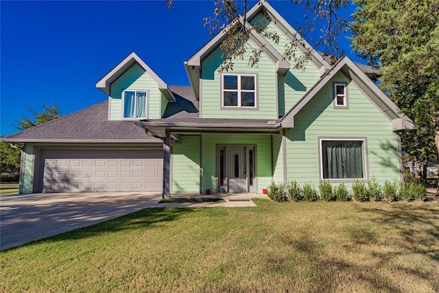 view of front of property with a front yard, a garage, and a porch