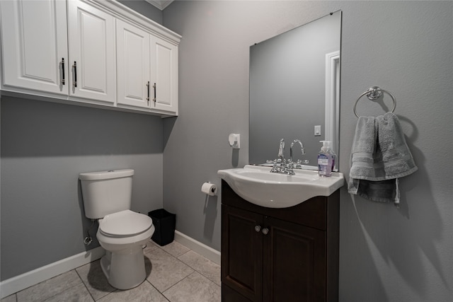 bathroom with vanity, toilet, and tile patterned flooring